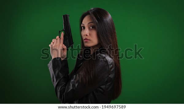 Young female agent with a gun in her hand -
studio photography