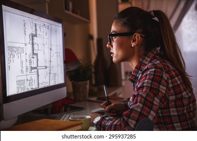 Young Female Architect Working At Home.