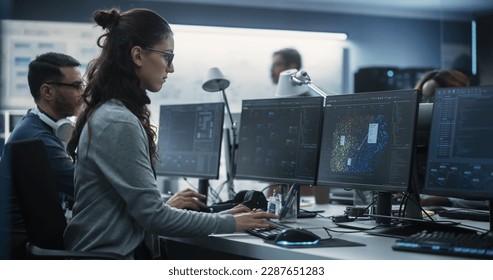 Young Female Artificial Intelligence Engineer Working on Computer in a Technological Office. Young Specialist Writing Software Code for an Innovative Big Data Blockchain Project. Photo from the Back
