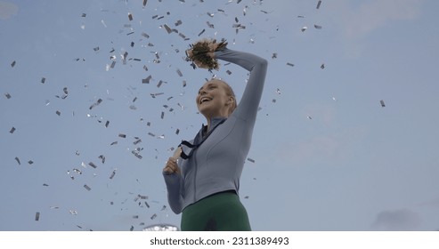 Young Female Athlete Celebrates a Win on a podium, receives a gold medal - Powered by Shutterstock