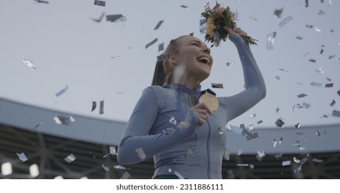 Young Female Athlete Celebrates a Win on a podium, receives a gold medal