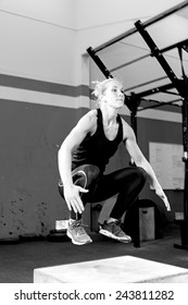 Young Female Athlete Doing A Box Jump At The Gym - Focus On The Woman