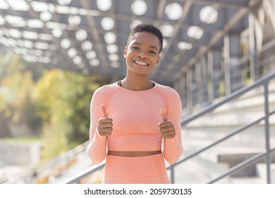 Young female athlete looks at the camera and smiles, stubborn and motivated fitness trenes encourages sports and active lifestyle - Shutterstock ID 2059730135