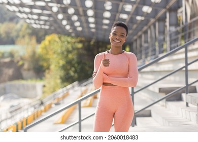 Young female athlete looks at the camera and smiles, stubborn and motivated fitness trenes encourages sports and active lifestyle - Shutterstock ID 2060018483
