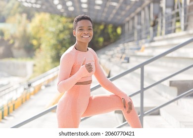 Young female athlete looks at the camera and smiles, stubborn and motivated fitness trenes encourages sports and active lifestyle - Shutterstock ID 2060770421