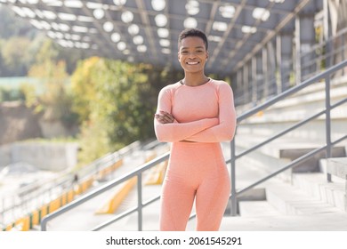 Young female athlete looks at the camera and smiles, stubborn and motivated fitness trenes encourages sports and active lifestyle - Shutterstock ID 2061545291
