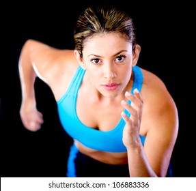 Young Female Athlete Running - Isolated Over A Black Background