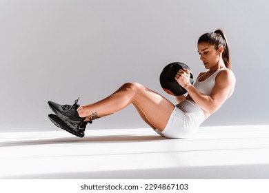 Young female athlete training in a gym using sport equipment. Fit woman working out . Concept about fitness, wellness and sport preparation. - Powered by Shutterstock