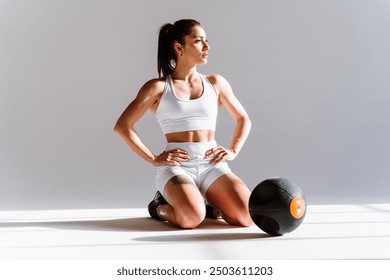 Young female athlete training in a gym using sport equipment. Fit woman working out . Concept about fitness, wellness and sport preparation. - Powered by Shutterstock