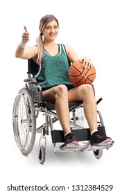 Young Female Athlete In A Wheelchair Holding Basketball And Showing Thumbs Up Isolated On White Background