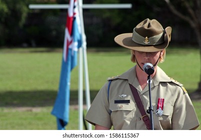 Young Female Australian Army Officer (soldier) Wearing Medal And Iconic Slouch Hat Gives Emotional Speech During ANZAC Rememberance Service In Front Of Australian Flags On The Gold Coast, Australia.