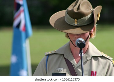 Young Female Australian Army Officer (soldier) Wearing Medal And Iconic Slouch Hat Gives Emotional Speech During ANZAC Rememberance Service In Front Of Australian Flags On The Gold Coast, Australia.