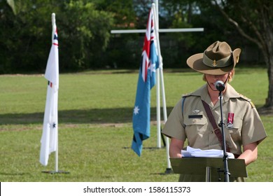 Young Female Australian Army Officer (soldier) Wearing Medal And Iconic Slouch Hat Gives Emotional Speech During ANZAC Rememberance Service In Front Of Australian Flags On The Gold Coast, Australia.