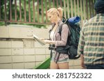 Young female backpacker using map in the city