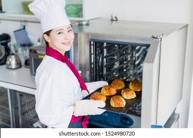 Young Female Baker Baking Breads.