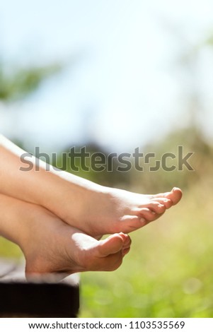 young female barefoot feets in the nature, copyspace