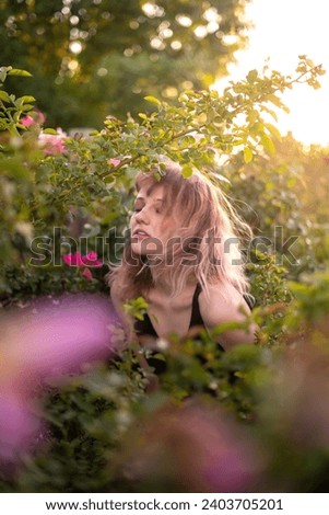 Young Female Black Top Windy Wavy Hair Portrait in Rose Flower Garden Golden Hour