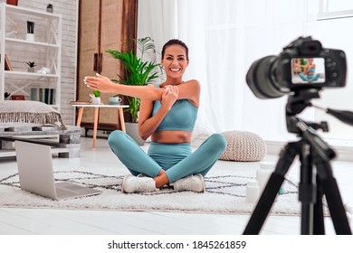 Young female blogger recording sports video at home. Stay at home activities. Prevent infection from the pandemia. - Powered by Shutterstock