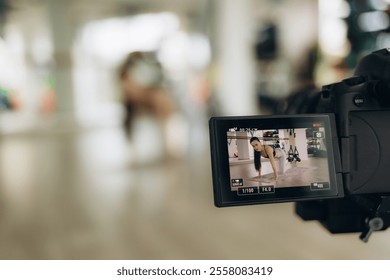 Young female blogger recording sports video at home - Powered by Shutterstock