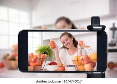 Young Female Blogger And Vlogger And Online Influencer Live Streaming A Cooking Show On Social Media Using A Smartphone