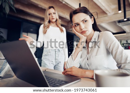 Young female boss scolding her female subordinate for bad work results