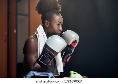 A young female boxer in a locker room focused on the match - Powered by Shutterstock