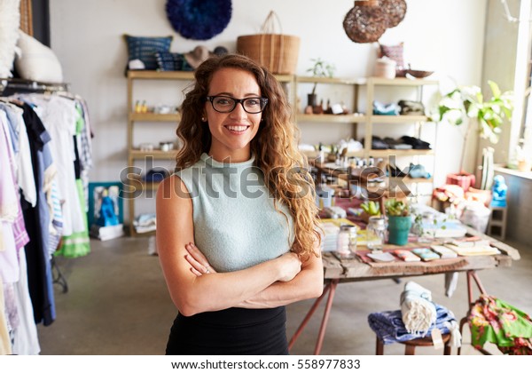 Young\
female business owner in a clothes shop,\
portrait