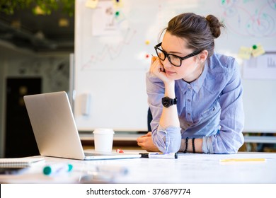 Young female businesswoman in the office - Shutterstock ID 376879774