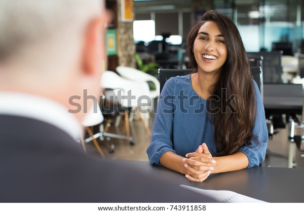 Young female\
candidate laughing at job\
interview
