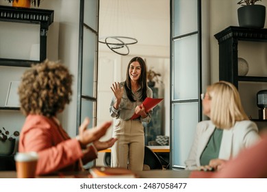 Young female candidate walking into a office, holding a CV, ready to have a job interview with a HR team - Powered by Shutterstock