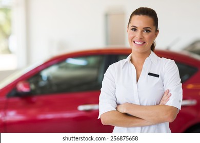 Young Female Car Sales Consultant Working In Showroom