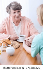 Young female carer keeping company senior woman - Shutterstock ID 371388220