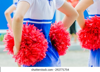 Young Female Cheerleaders Holding Pom-poms During Competitions