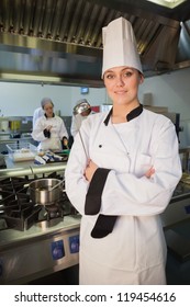 Young Female Chef Holding Ladle In The Kitchen