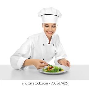 Young Female Chef Making Salad On White Background