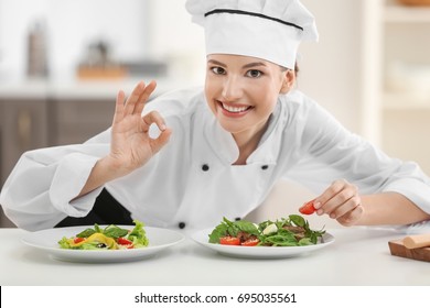 Young Female Chef With Tasty Dishes In Kitchen