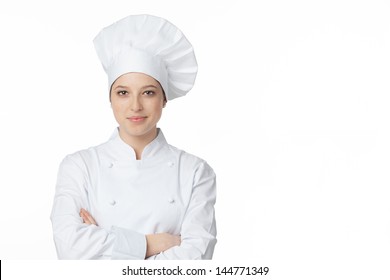 A Young, Female Chef In A Traditional Hat And Coat. 