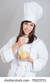 Young Female Chef Using The Mortar And Pestle