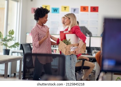 A young female clerk in a sad atmosphere in the office says goodbye to a colleague after she was fired. Employees, job, office - Powered by Shutterstock