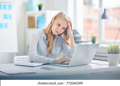 Young female concentrating on network while preparing for report or looking for online data for seminar - Shutterstock ID 772045399