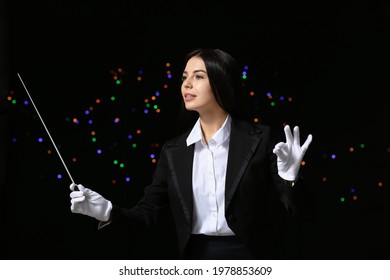 Young Female Conductor On Dark Background