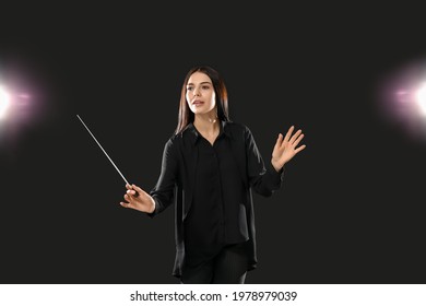 Young Female Conductor On Dark Background