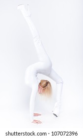 Young Female Contortionist In White Glossy Suit Stretching