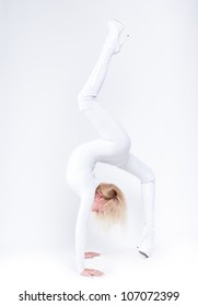 Young Female Contortionist In White Glossy Suit Poses