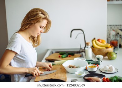 Young Female Cooker Making Marinade For Raw Meat On Kitchen Table