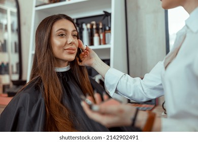 Young Female Customer Getting Blush Powder On Her Cheek With A Brush. Beauty Salon Services