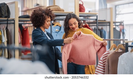 Young Female Customer Shopping in Clothing Store, Retail Sales Associate Helps with Advice. Diverse People in Fashionable Shop, Choosing Stylish Clothes, Colorful Brand with Sustainable Designs