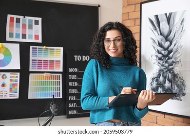 Young female designer working in office - Shutterstock ID 2059503779