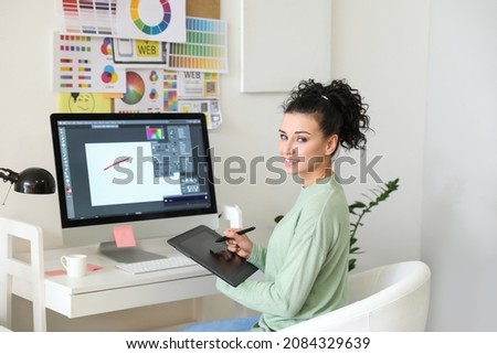Young female designer working in office