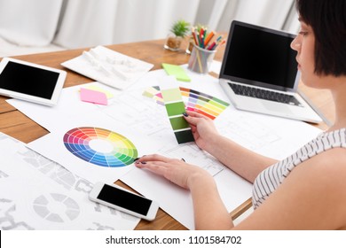 Young female designers working with color palette in modern workplace interior, copy space. House design project at office desk. - Shutterstock ID 1101584702